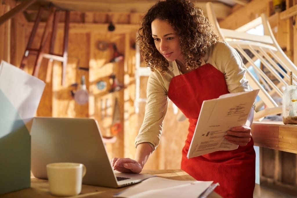 a small business owner recycling furniture from her garden workshop